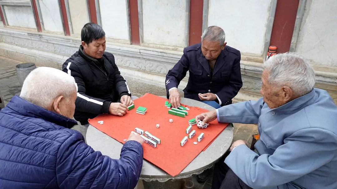 a group of people sitting around a table playing a game