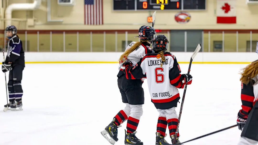 a group of young people playing a game of ice hockey