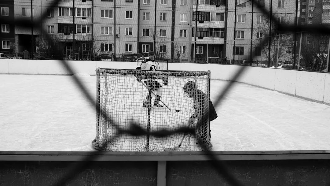 person in black and white checkered dress shirt playing basketball on snow covered field