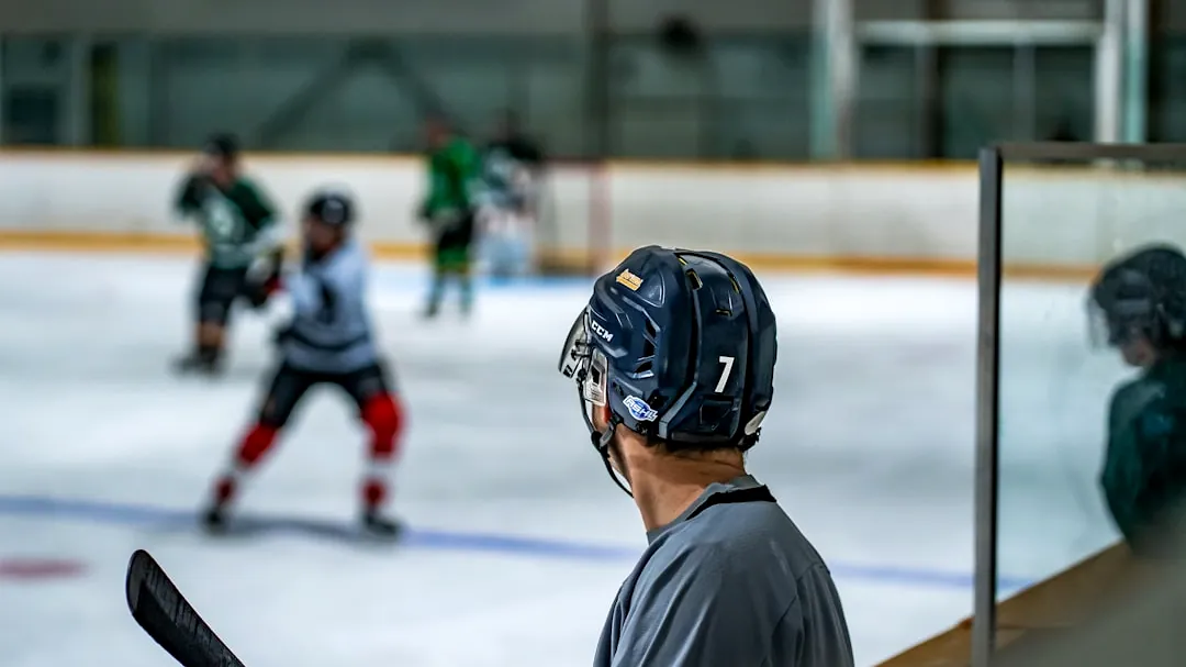 a group of young men playing a game of ice hockey