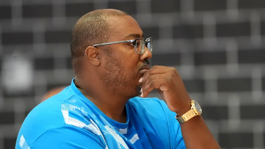 a man in a blue shirt with a watch on his left hand