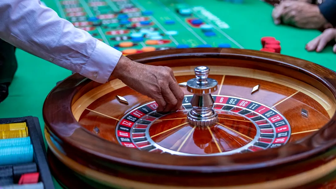 a man is playing a game of roule on a green table