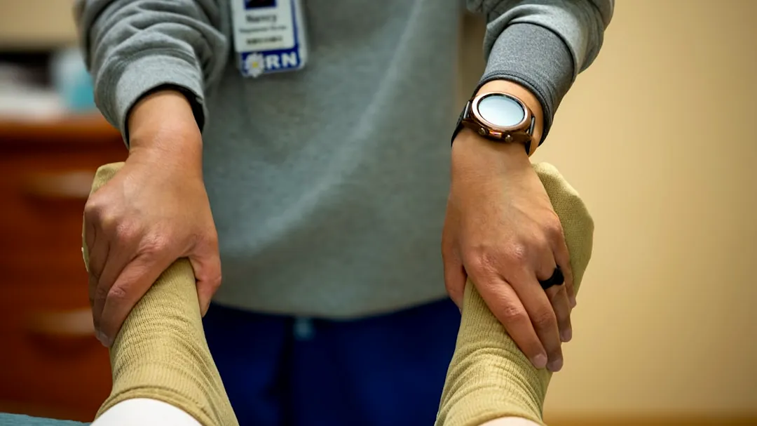A nurse is performing physical therapy.