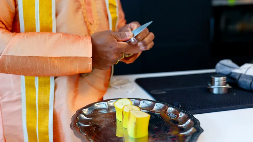 A woman standing in front of a counter holding a cell phone