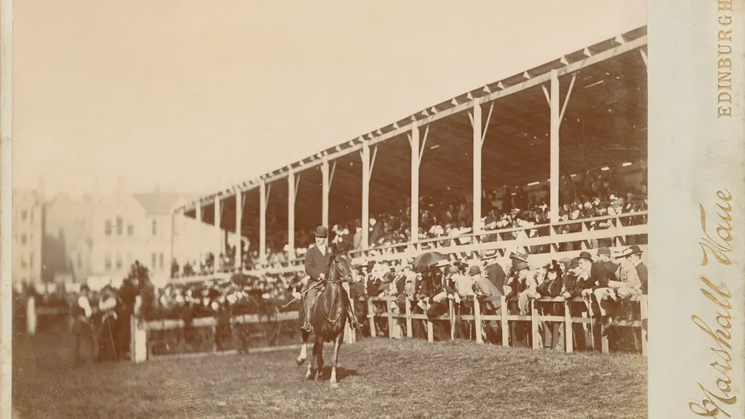 an old photo of a man on a horse in front of a crowd