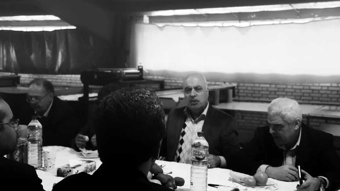 grayscale photo of men eating