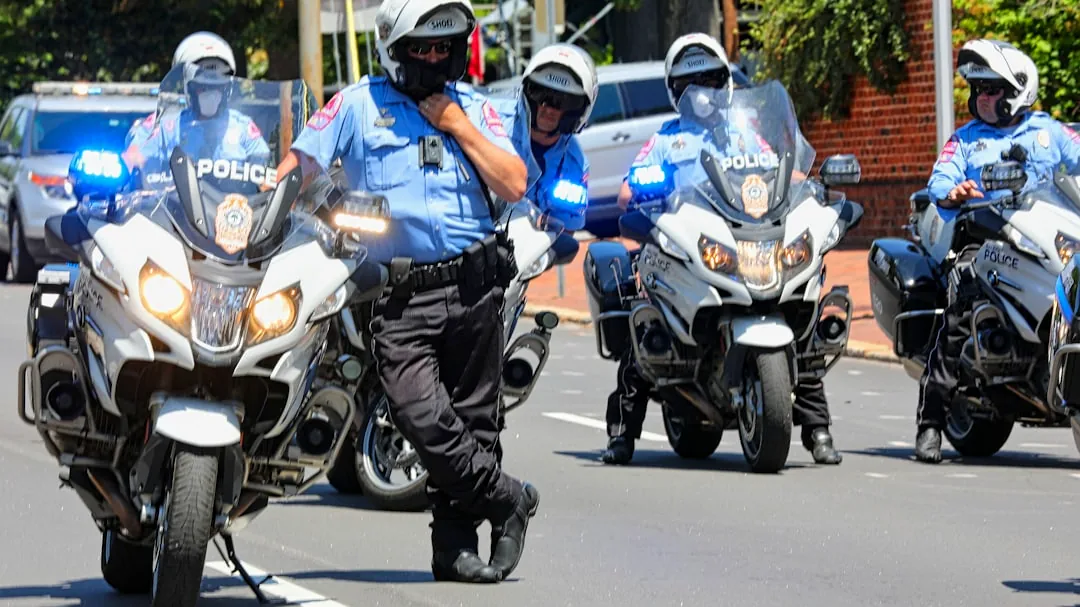 man in blue and white motorcycle suit riding on motorcycle during daytime