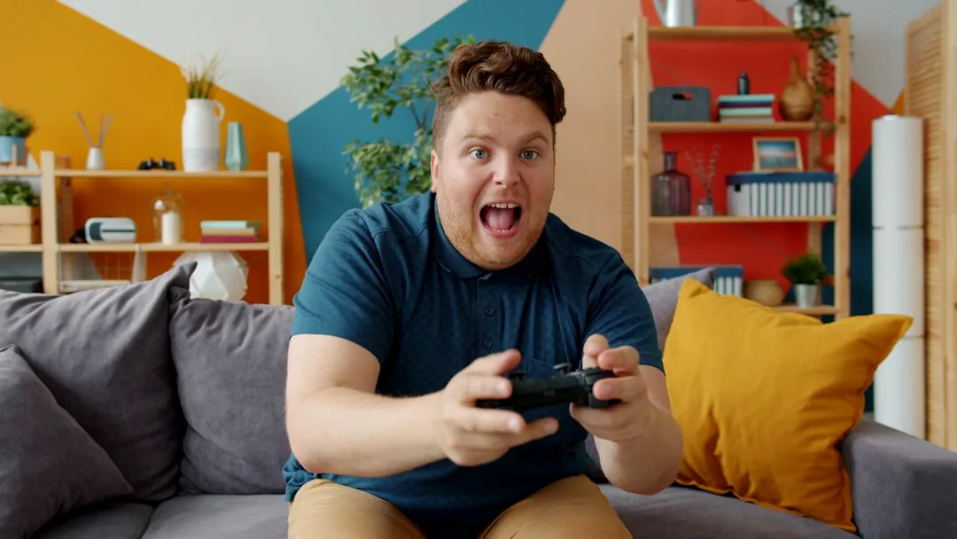 Man playing video games with excited expression