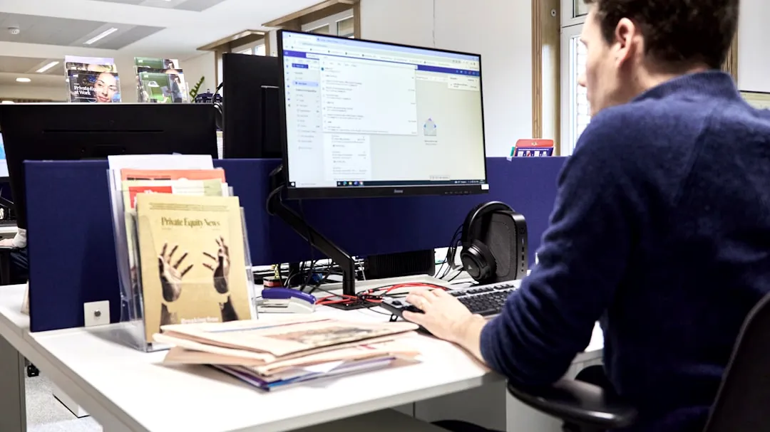 Man working at a computer in an office.