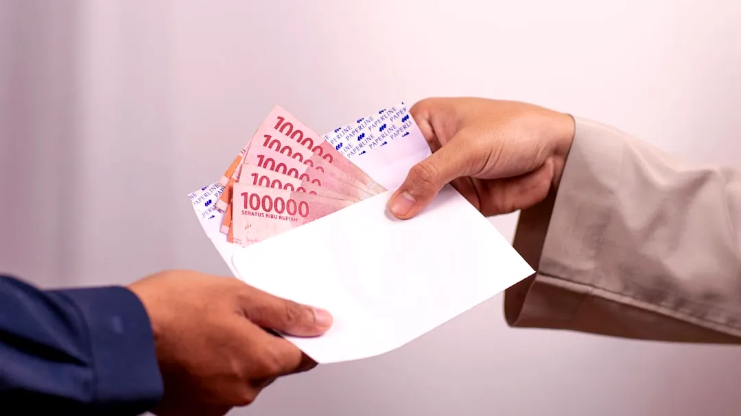 Money is being handed over between two people.