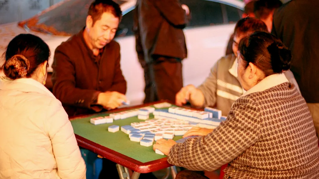 People are playing a game of mahjong together.