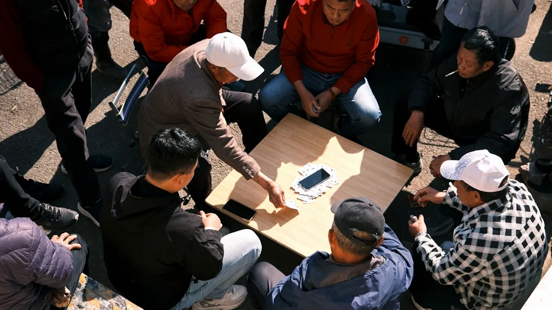 People play a game around a table.