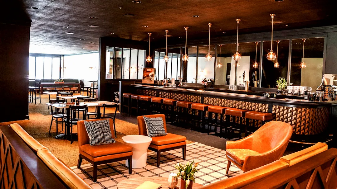 a bar with chairs and a bar counter