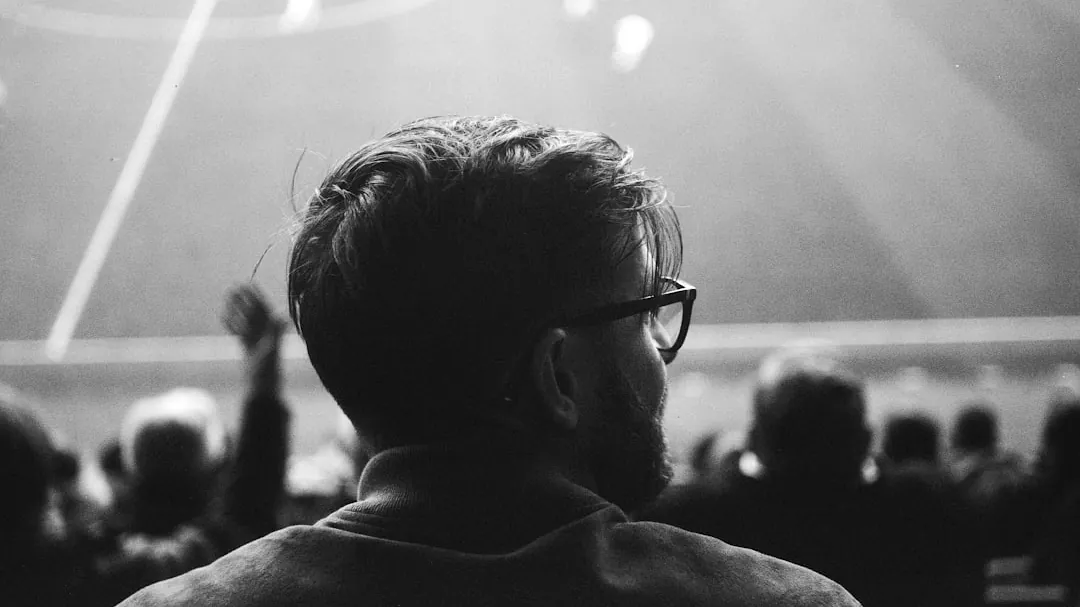a black and white photo of a man at a soccer game