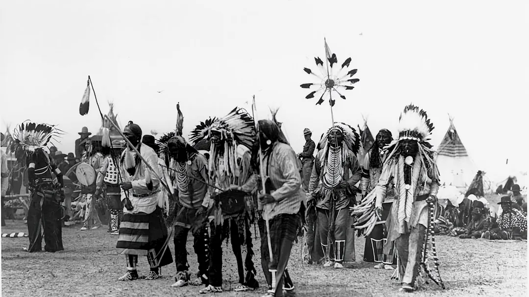 a group of native american men standing next to each other