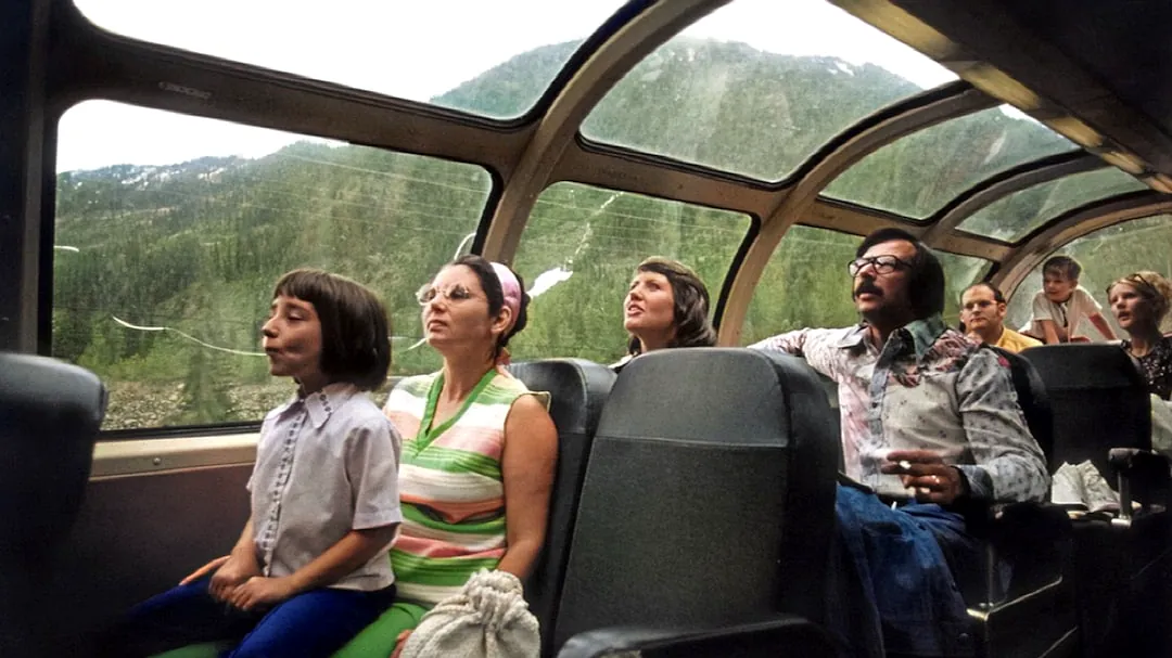 a group of people sitting around a car window