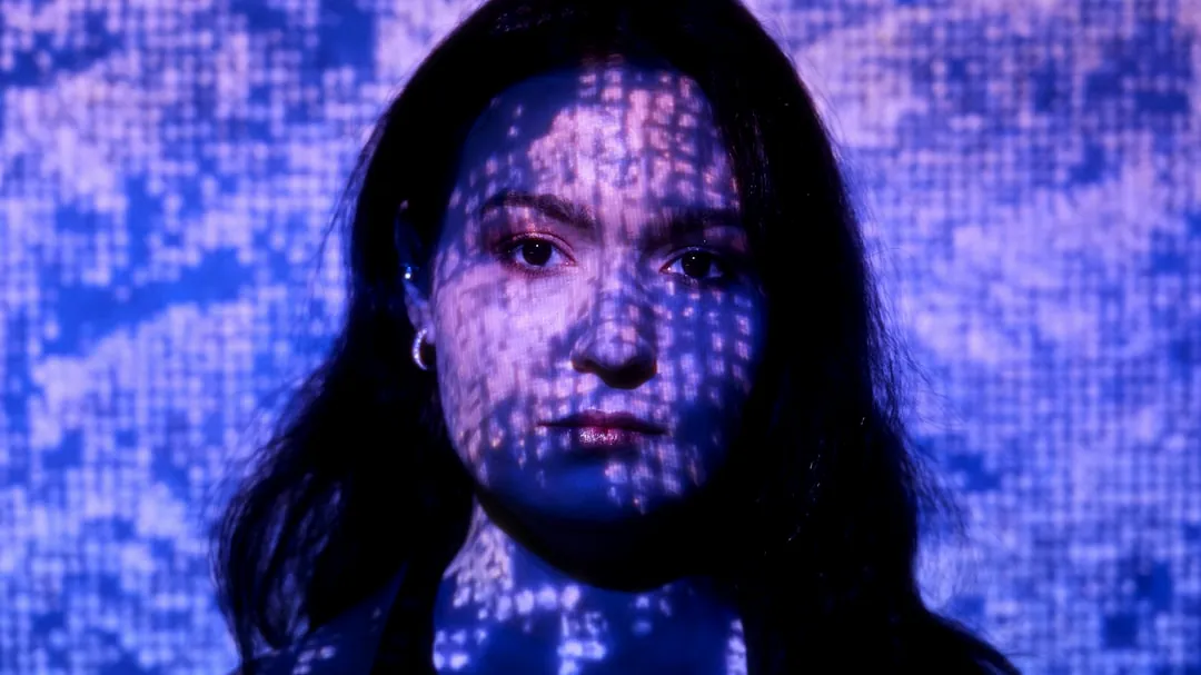 a woman in a black shirt and a blue background
