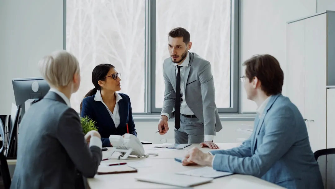 Business professionals in a meeting around a table.