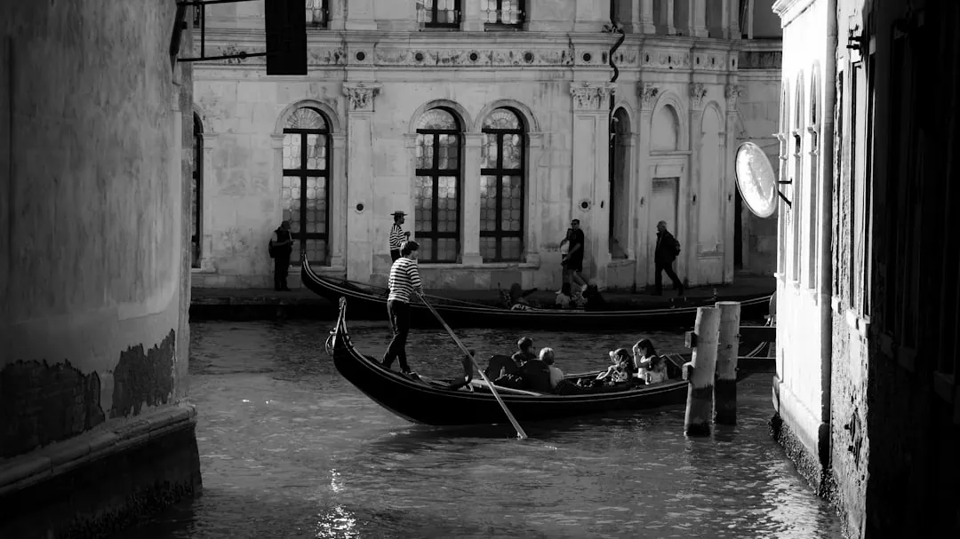 Gondola carrying tourists down a venetian canal