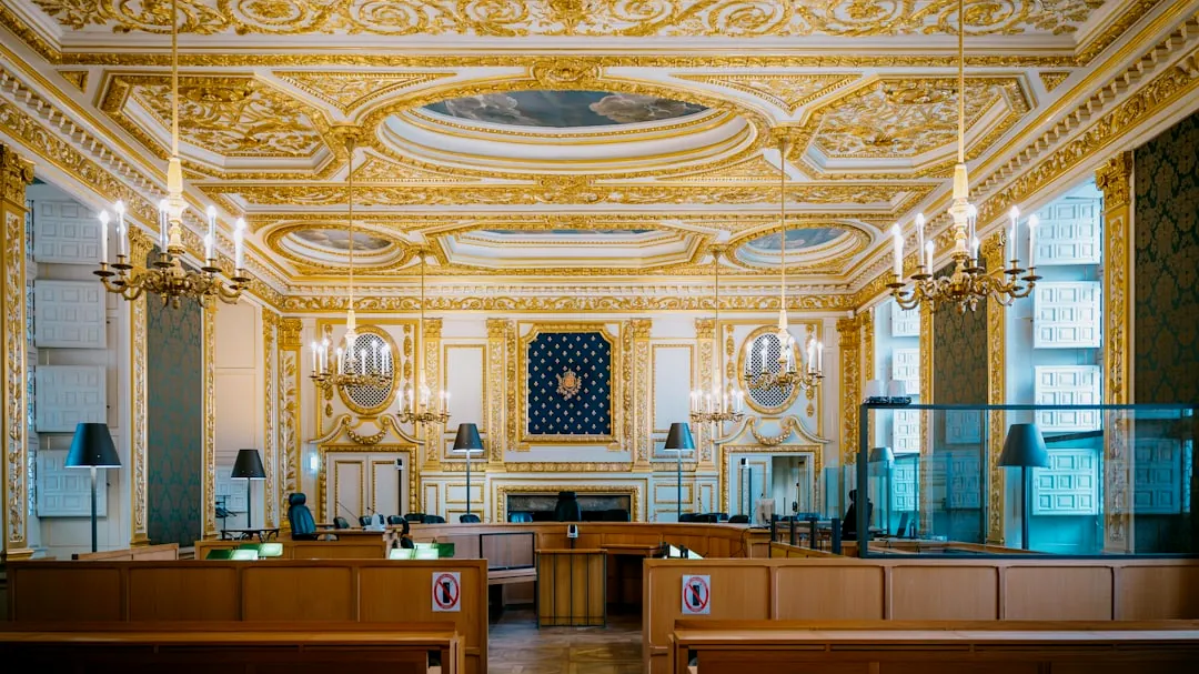 Ornate courtroom with gilded decorations and chandeliers