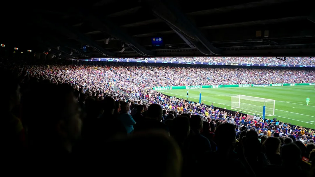 people watching football at stadium during daytime